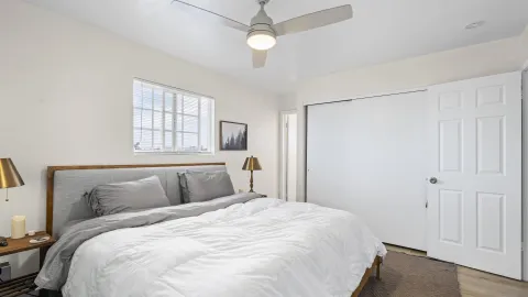 a bedroom with a large bed and a chandelier