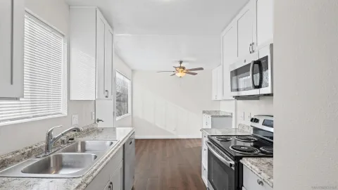 a kitchen that has a sink and a stove