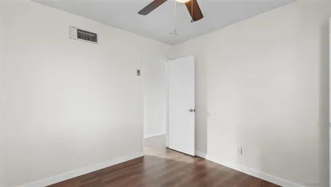 an empty room with ceiling fan