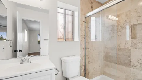 a bathroom with a sink toilet and shower