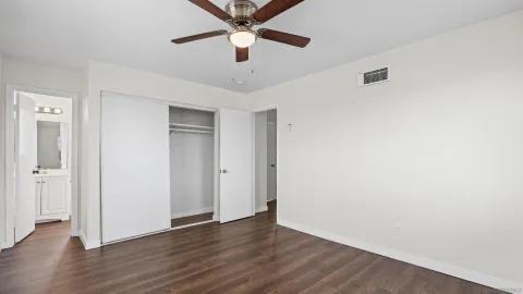 a view of an empty room with wooden floor