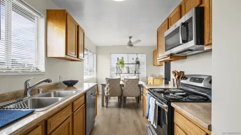 a kitchen with stainless steel appliances granite countertop a sink stove top oven and cabinets