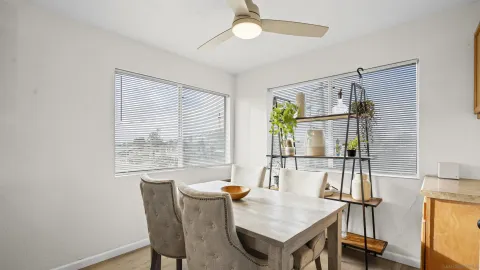 a dining room with furniture and a window