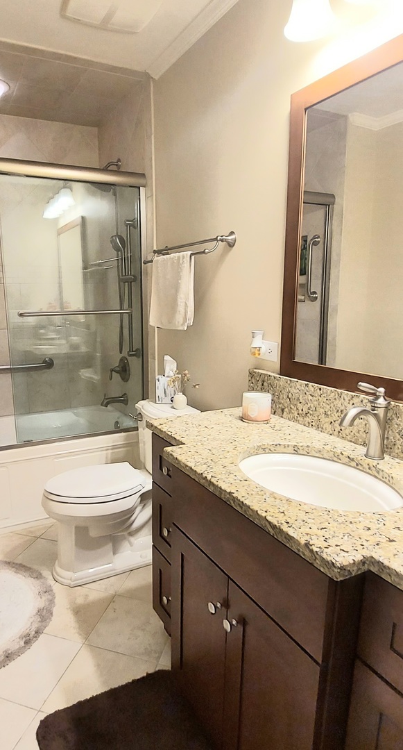 100 Hamlet Circle Montgomery, IL 60538 - Photo 38 of 42 a bathroom with a granite countertop sink a toilet a mirror and shower