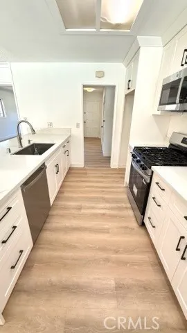 a spacious bathroom with sink and mirror