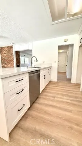 a kitchen with granite countertop white cabinets and white appliances