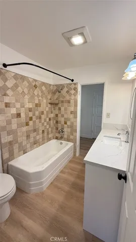 a bathroom with a sink a toilet and a bathtub