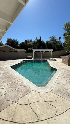 a view of a swimming pool with a lounge chair