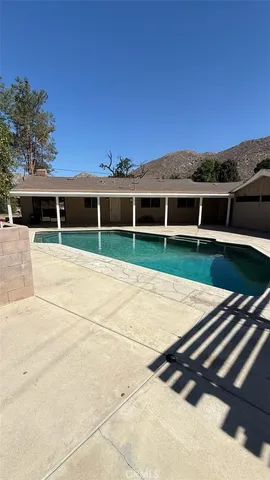 a view of outdoor space with swimming pool and barbeque oven
