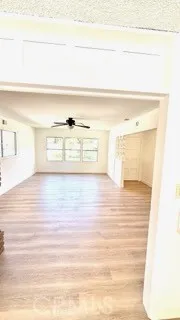 a view of a room with wooden floor