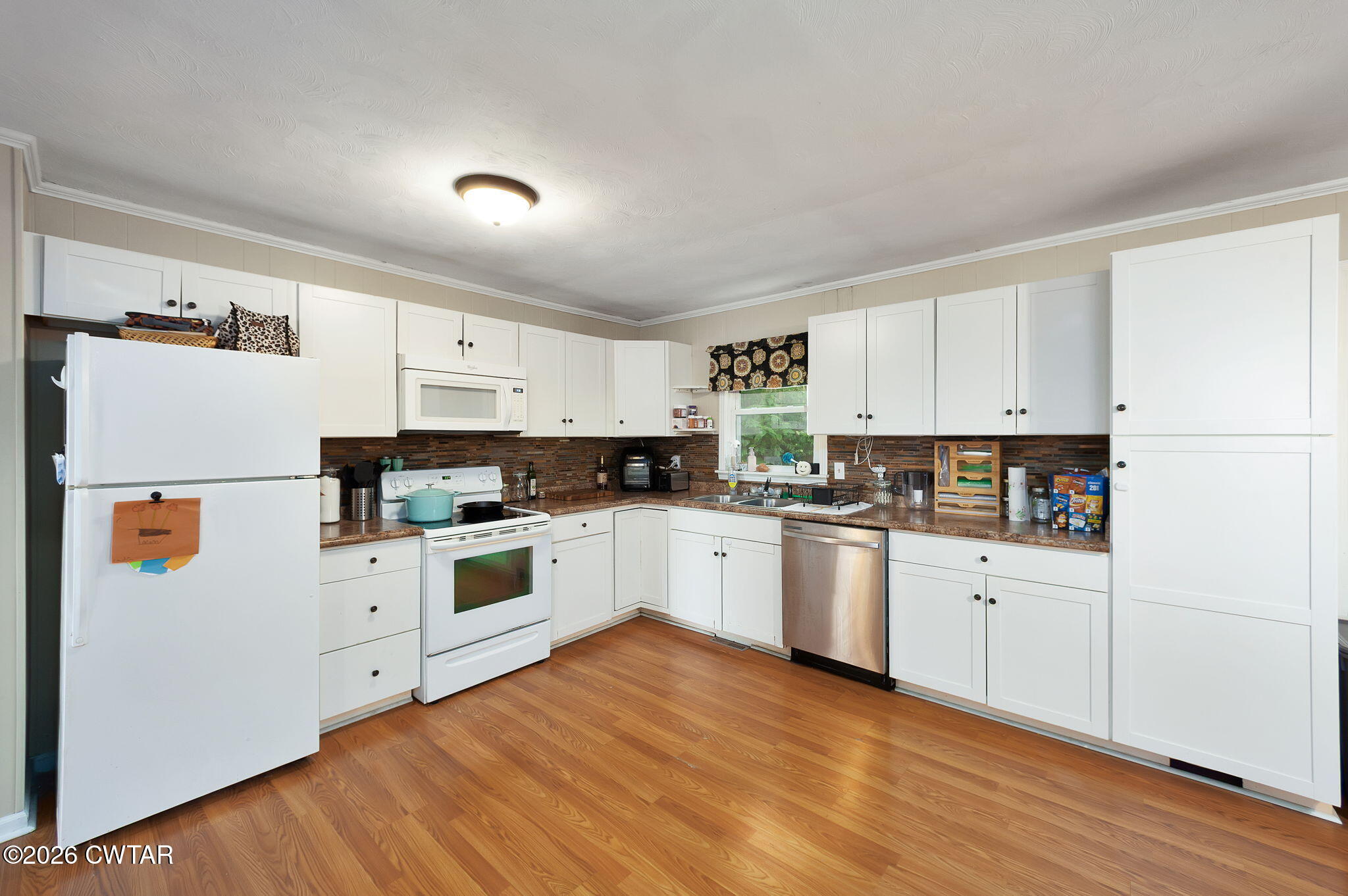 1921 Nance Road Alamo, TN 38001 - Photo 17 of 29 a kitchen with white cabinets and white appliances