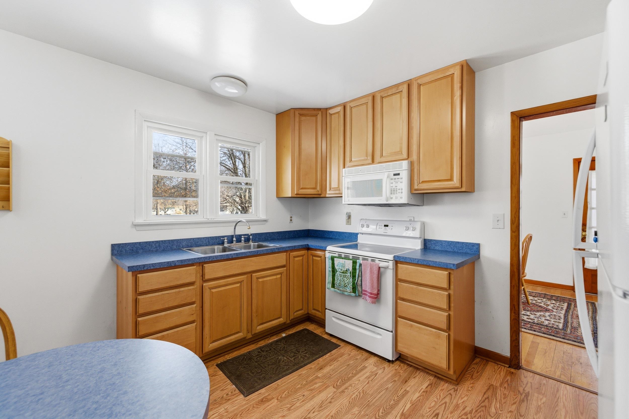 405 North River Road Bridgewater, VA 22812 - Photo 2 of 55 a kitchen with stainless steel appliances granite countertop a stove a sink and a microwave with wooden floor