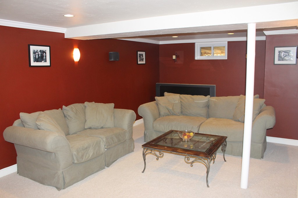 67 Colasanti Road Weymouth, MA 02191 - Photo 15 of 16 a living room with furniture and a lamp