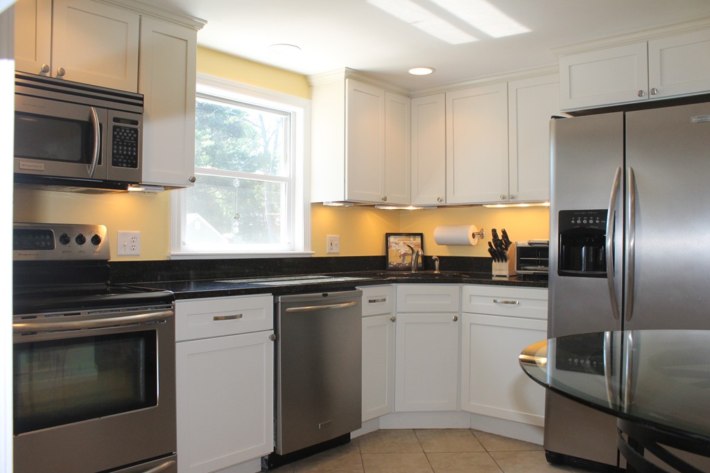 67 Colasanti Road Weymouth, MA 02191 - Photo 2 of 16 a kitchen with granite countertop a sink stainless steel appliances and cabinets