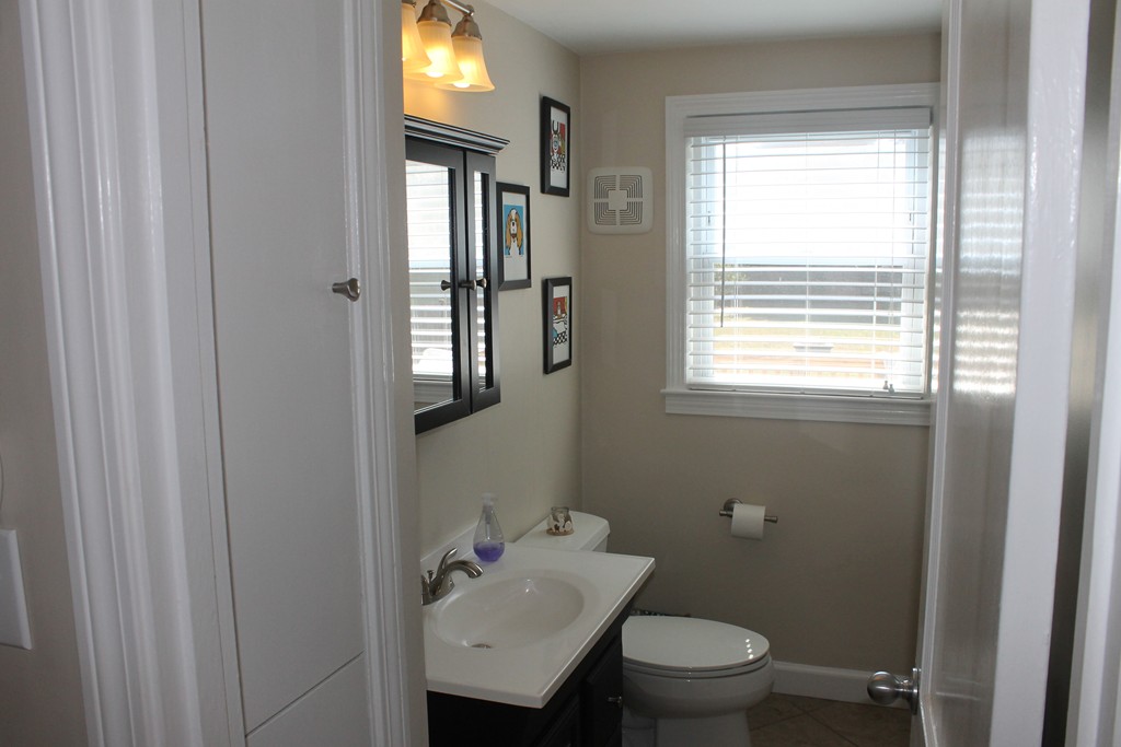 67 Colasanti Road Weymouth, MA 02191 - Photo 5 of 16 a bathroom with a toilet sink and mirror