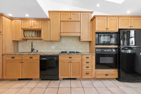 a kitchen with stainless steel appliances granite countertop a stove and a refrigerator