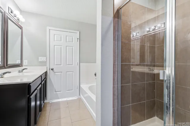a bathroom with a shower sink and mirror