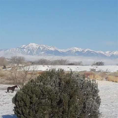 a view of a chairs and table in a backyard