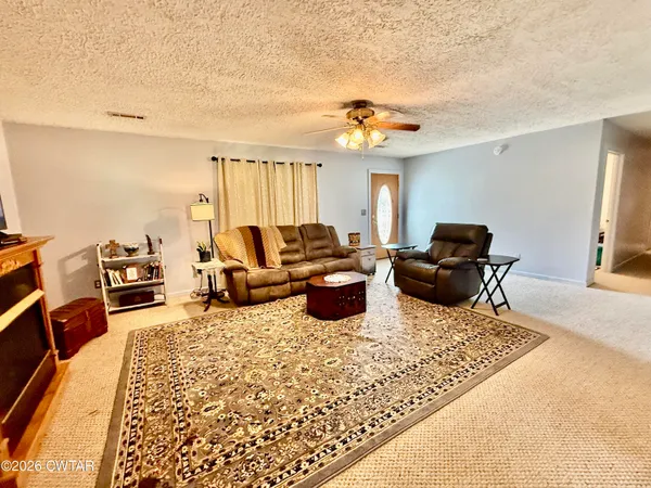 a living room with furniture rug and window