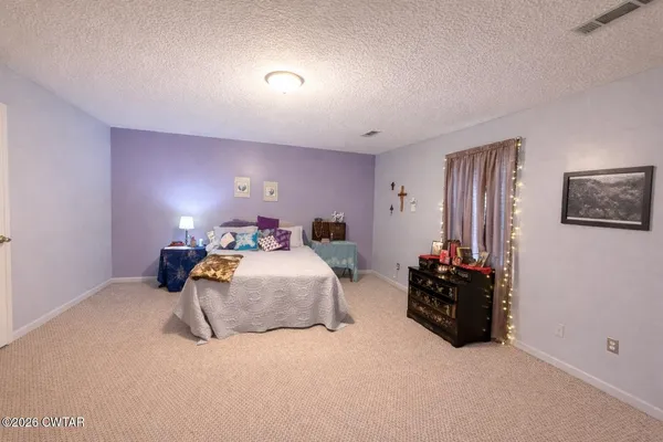a bedroom with bed and a couch
