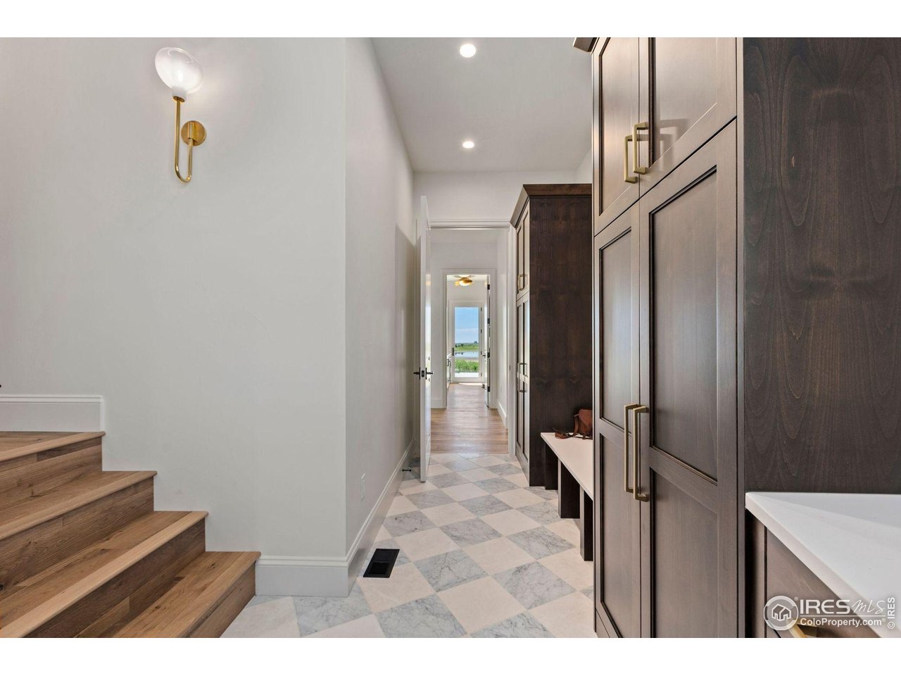 2568 Southwind Road Berthoud, CO 80513 - Photo 27 of 40 a view of a hallway with wooden floor and staircase