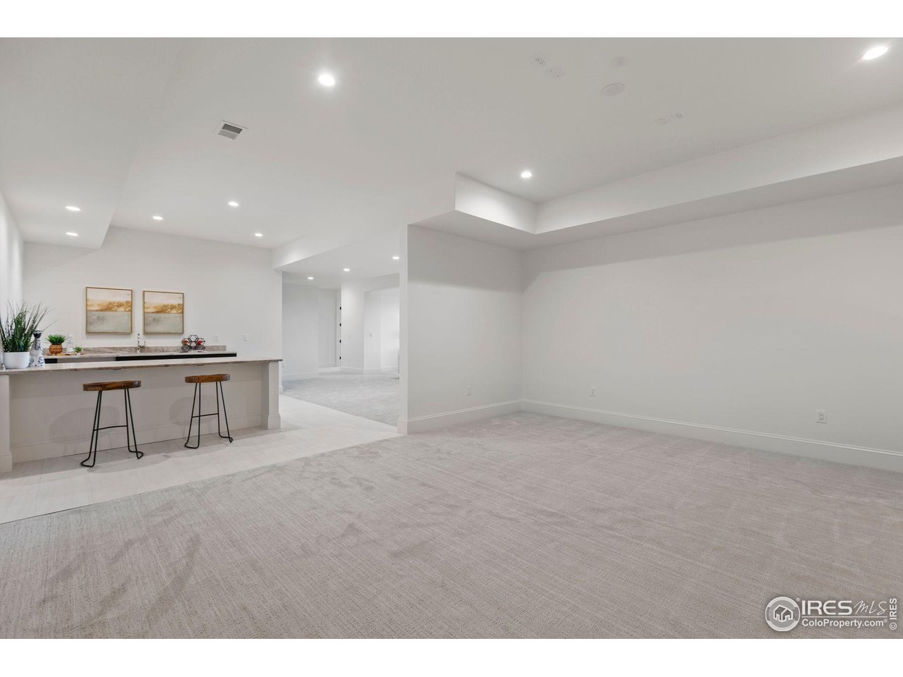 2568 Southwind Road Berthoud, CO 80513 - Photo 31 of 40 a view of an empty room with kitchen and furniture