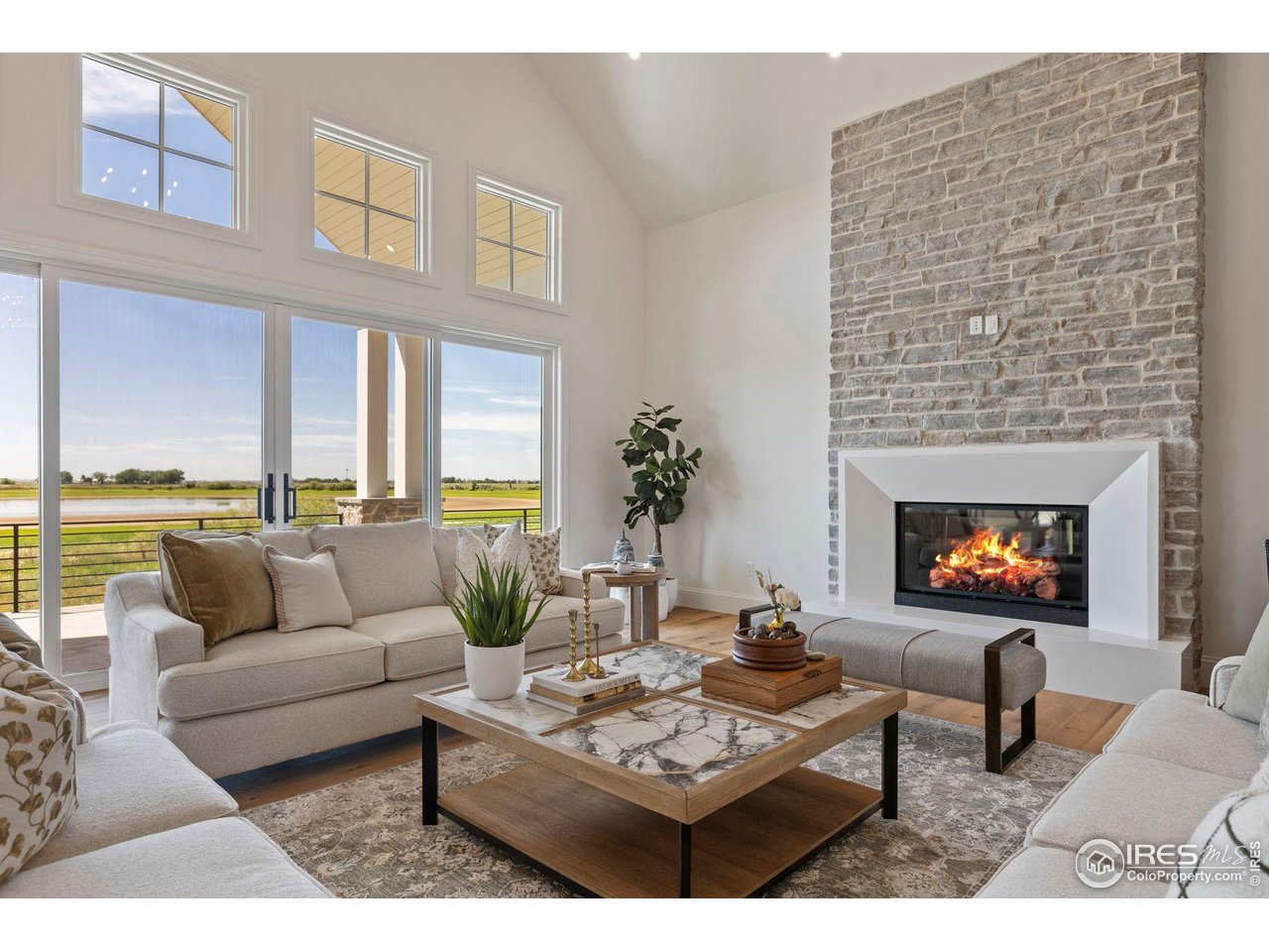2568 Southwind Road Berthoud, CO 80513 - Photo 38 of 40 a living room with furniture and a fireplace