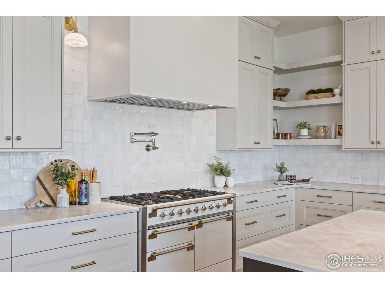 2568 Southwind Road Berthoud, CO 80513 - Photo 9 of 40 a kitchen with white cabinets and appliances