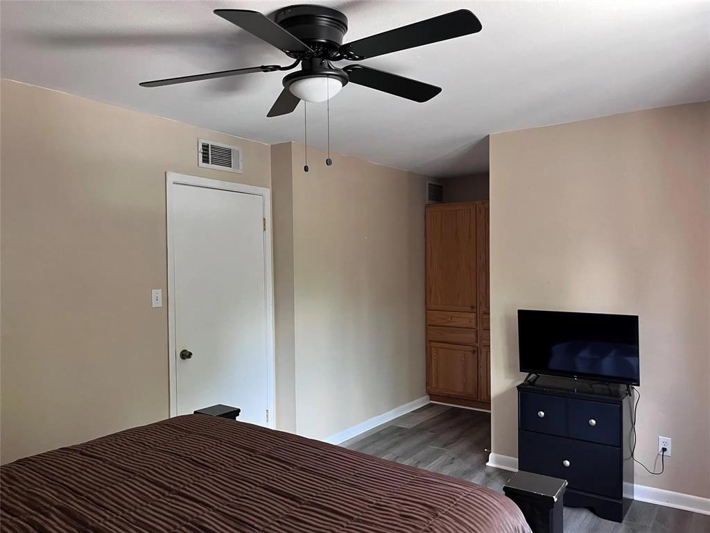 7000 Creswell Road, Unit 217 Shreveport, LA 71106 - Photo 9 of 17 a bedroom with a bed and a flat tv screen on a dresser