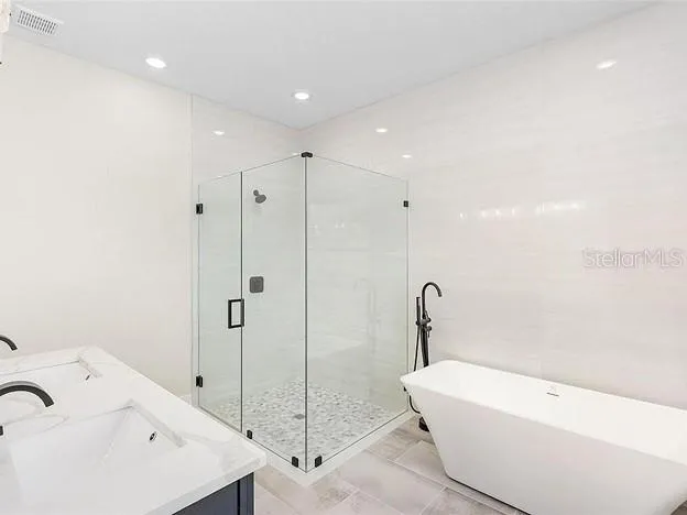 a bathroom with a bathtub and a sink