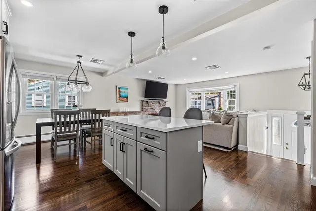a kitchen with counter top space and wooden floor