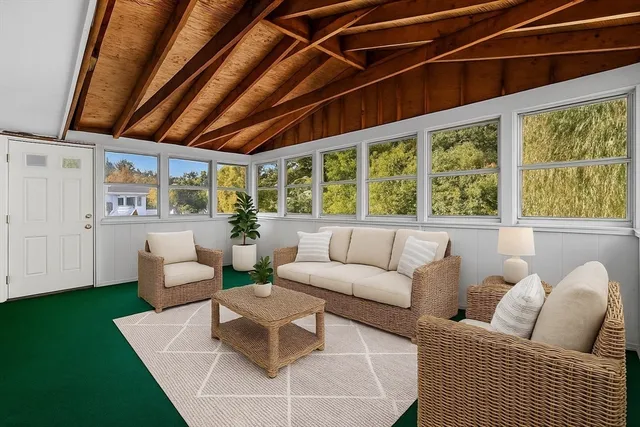 a living room with furniture and a floor to ceiling window