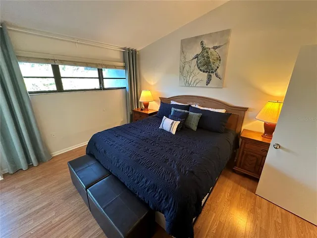 a bedroom with a bed and balcony view