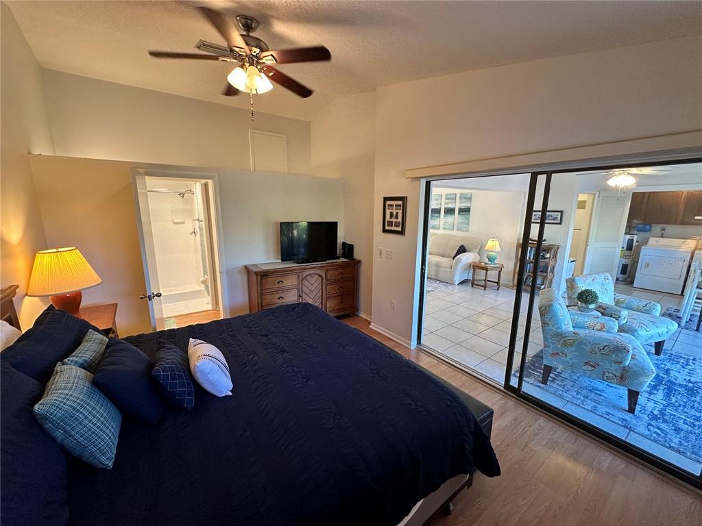 4578 Red Maple, Unit 904 Bradenton, FL 34210 - Photo 15 of 37 a bedroom with a bed and balcony view