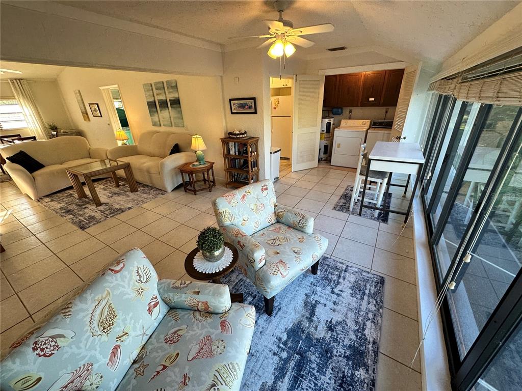 4578 Red Maple, Unit 904 Bradenton, FL 34210 - Photo 19 of 37 a living room with furniture and a flat screen tv