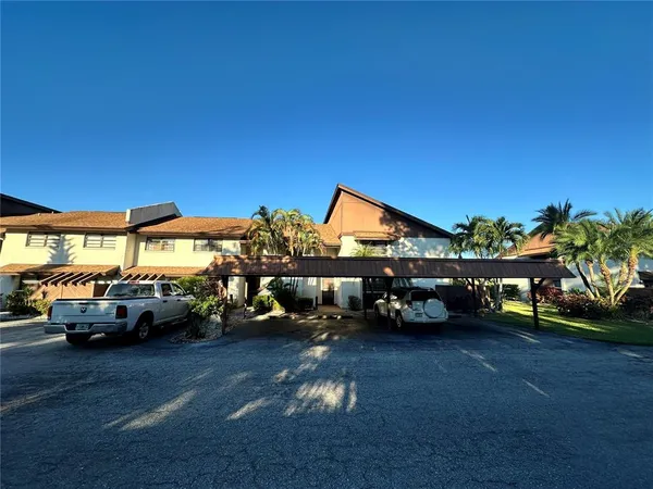 a view of cars parked in front of a house