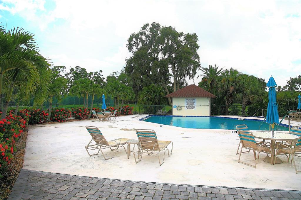4578 Red Maple, Unit 904 Bradenton, FL 34210 - Photo 30 of 37 a view of a patio with a dining table and chairs with a fire pit