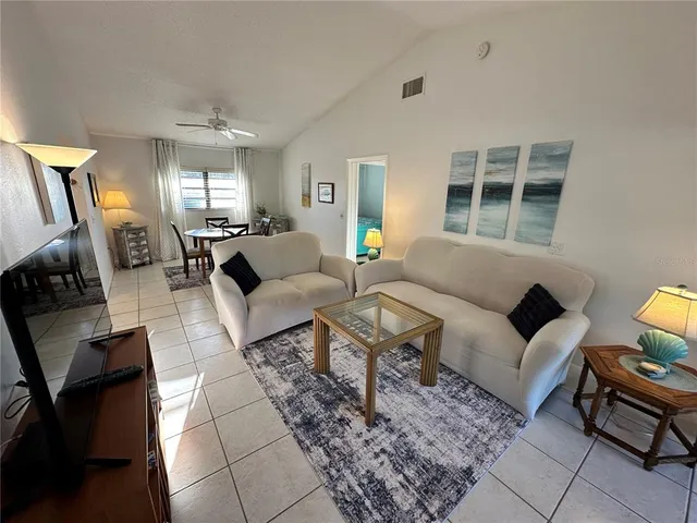 a living room with furniture a rug and a chandelier