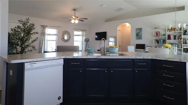 a bathroom with a granite countertop sink a large mirror and a shower