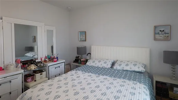 a bedroom with a bed and a dresser