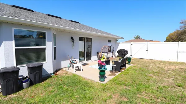 a view of a house with a backyard