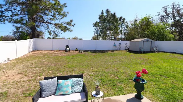 a view of swimming pool with a backyard and trees