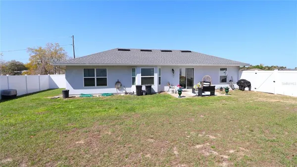 a view of a house with backyard and porch