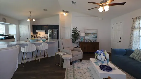 a living room with furniture and a chandelier
