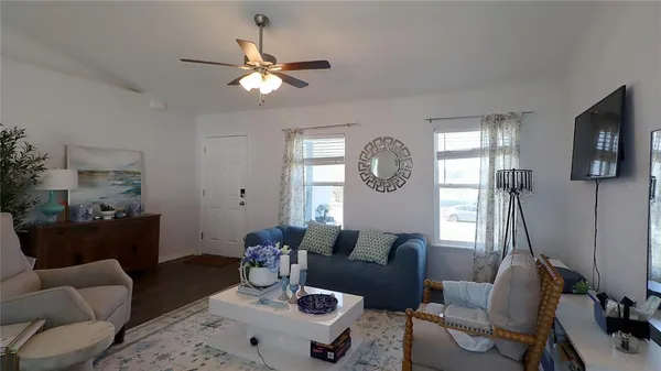 a living room with furniture and a large mirror