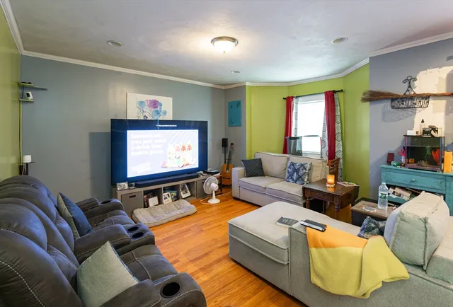 a living room with furniture and a flat screen tv