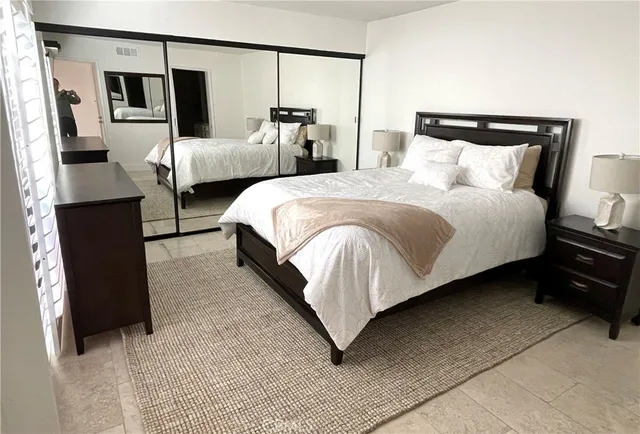 a bedroom with bed and wooden floor