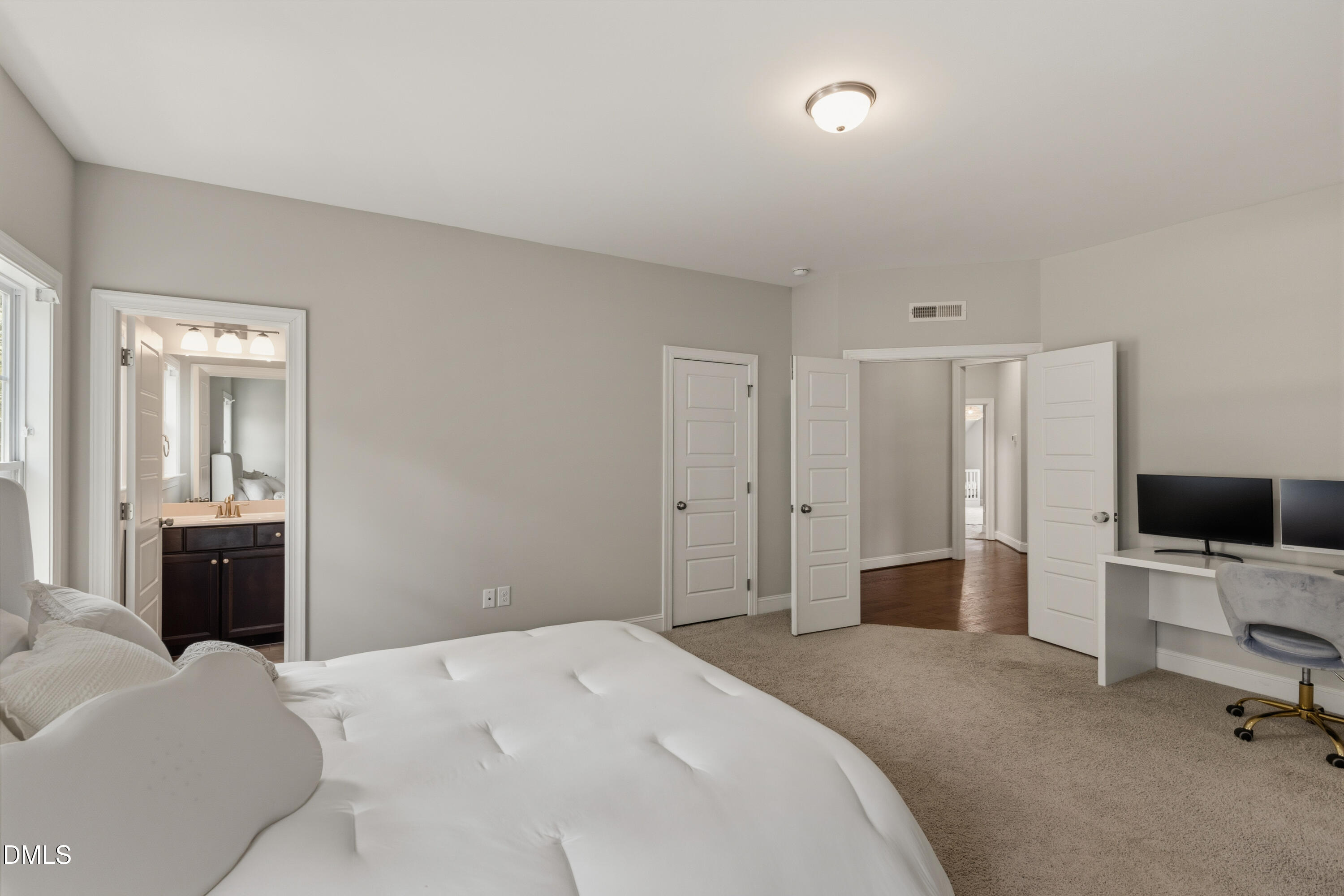 7421 Stonehenge Farm Lane Raleigh, NC 27613 - Photo 21 of 48 a bedroom with a bed and a flat screen tv