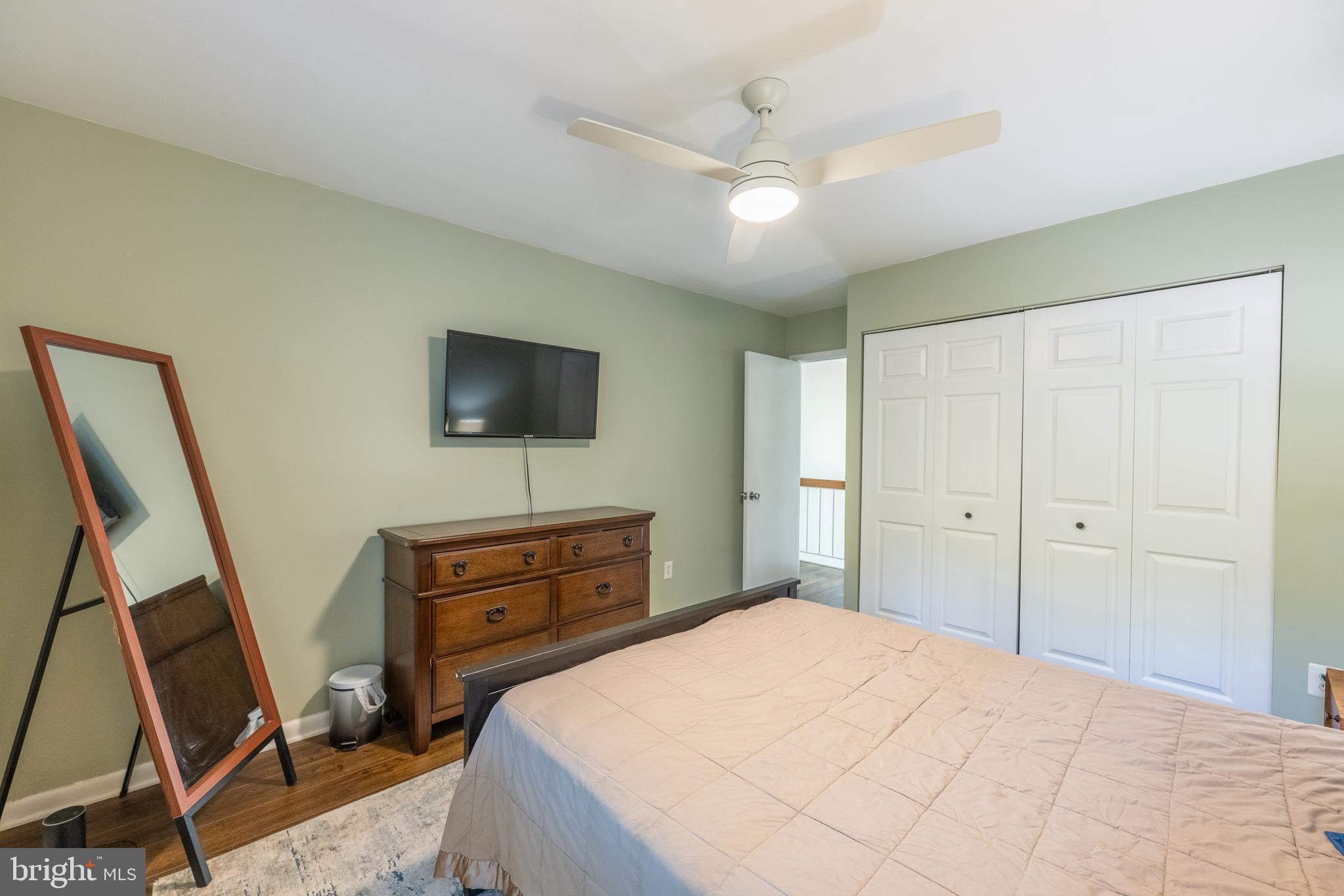 11917 Barrel Cooper Court Reston, VA 20191 - Photo 27 of 59 a bedroom with a bed and a flat screen tv