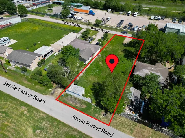 an aerial view of a tennis ground and a yard